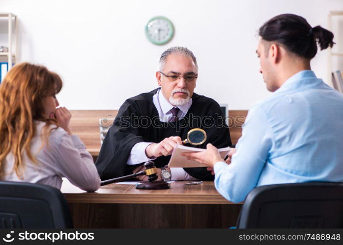 The young couple in the courthouse in divorce concept . Young couple in the courthouse in divorce concept