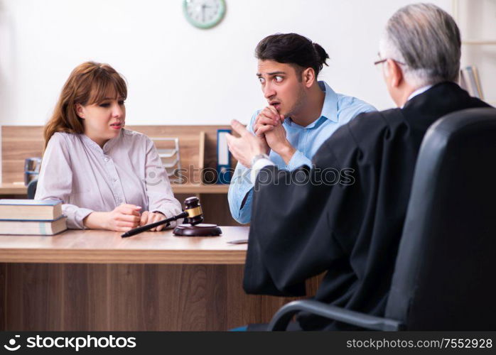 The young couple in the courthouse in divorce concept. Young couple in the courthouse in divorce concept