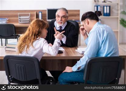 The young couple in the courthouse in divorce concept. Young couple in the courthouse in divorce concept