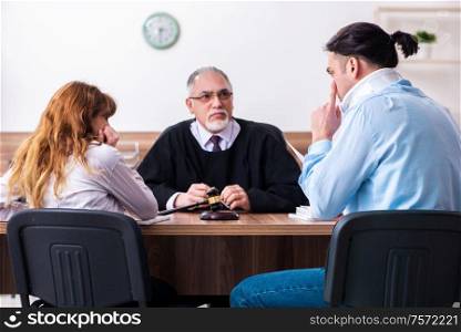 The young couple in the courthouse in divorce concept. Young couple in the courthouse in divorce concept