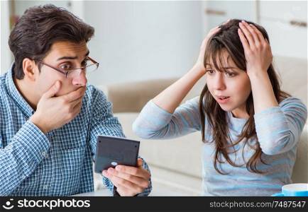 The young couple looking at family finance papers. Young couple looking at family finance papers