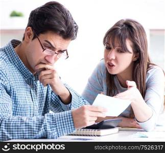 The young couple looking at family finance papers. Young couple looking at family finance papers