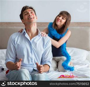 The young couple partying in the bed. Young couple partying in the bed