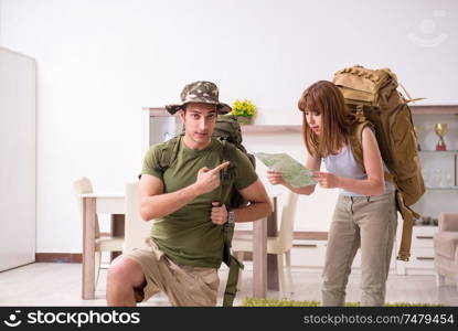 The young couple planning a trip to mountains. Young couple planning a trip to mountains