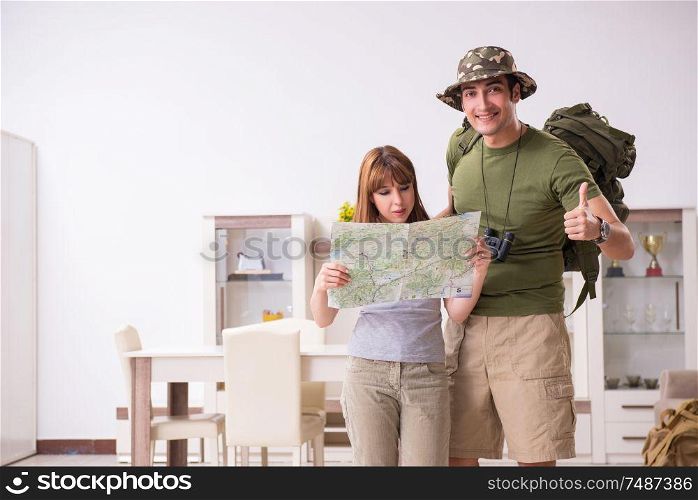 The young couple planning a trip to mountains. Young couple planning a trip to mountains