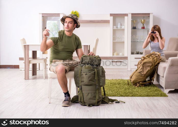 The young couple planning a trip to mountains. Young couple planning a trip to mountains