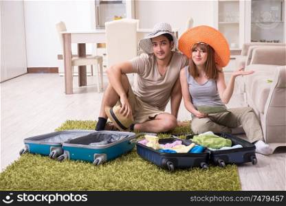 The young couple preparing for trip . Young couple preparing for trip