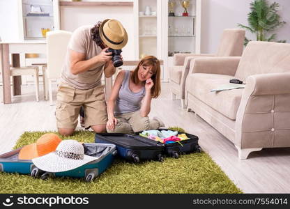 The young couple preparing for trip. Young couple preparing for trip