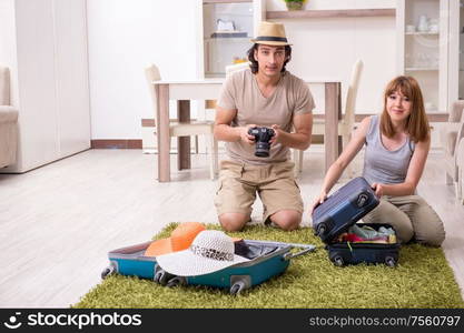 The young couple preparing for trip. Young couple preparing for trip