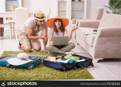 The young couple preparing for trip. Young couple preparing for trip