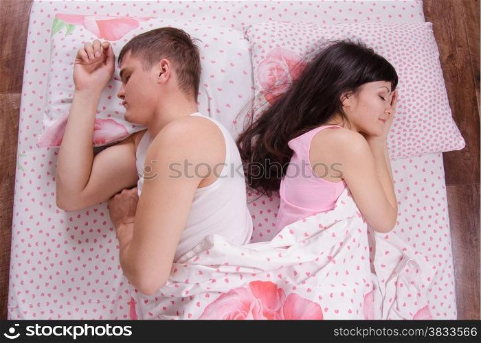 the young couple sleeping in the bed