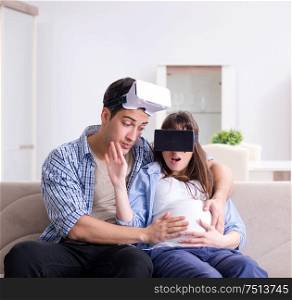 The young couple trying virtual reality glasses goggles. Young couple trying virtual reality glasses goggles