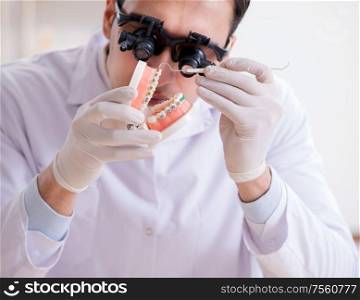The young dentist working in the dentistry hospital. Young dentist working in the dentistry hospital