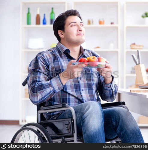 The young disabled husband preparing food salad. Young disabled husband preparing food salad