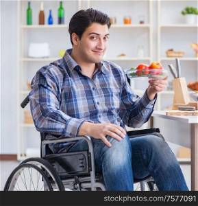 The young disabled husband preparing food salad. Young disabled husband preparing food salad