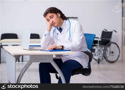 The young doctor being tired after night shift. Young doctor being tired after night shift