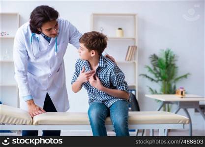 The young doctor examining schoolboy for regular check-up. Young doctor examining schoolboy for regular check-up