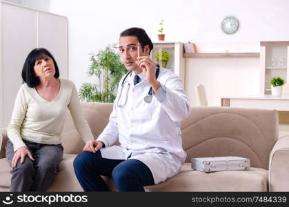 The young doctor examining senior old woman. Young doctor examining senior old woman
