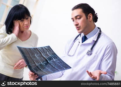 The young doctor examining senior old woman. Young doctor examining senior old woman