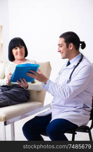 The young doctor examining senior old woman. Young doctor examining senior old woman