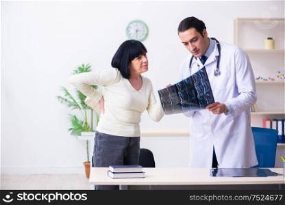 The young doctor examining senior old woman. Young doctor examining senior old woman