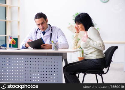 The young doctor examining senior old woman. Young doctor examining senior old woman