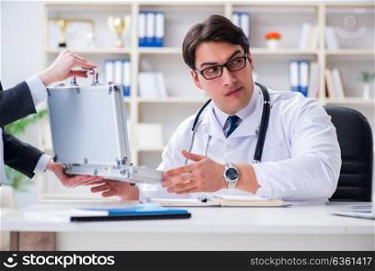 The young doctor in medical insurance fraud concept. Young doctor in medical insurance fraud concept