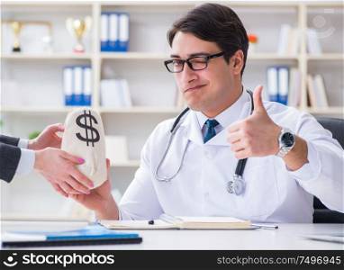 The young doctor in medical insurance fraud concept. Young doctor in medical insurance fraud concept