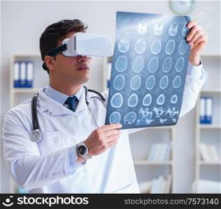 The young doctor looking at mri scan through vr glasses. Young doctor looking at MRI scan through VR glasses