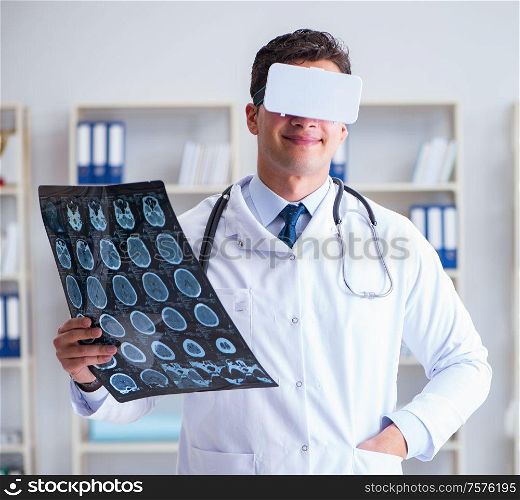 The young doctor looking at mri scan through vr glasses. Young doctor looking at MRI scan through VR glasses