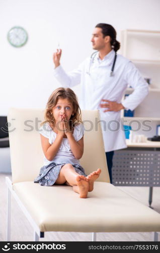 The young doctor pediatrician with small girl. Young doctor pediatrician with small girl