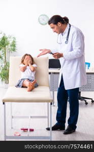 The young doctor pediatrician with small girl. Young doctor pediatrician with small girl