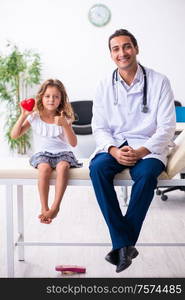 The young doctor pediatrician with small girl. Young doctor pediatrician with small girl