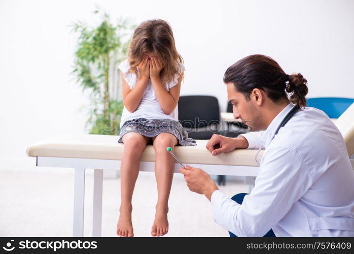 The young doctor pediatrician with small girl. Young doctor pediatrician with small girl