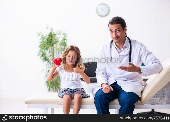 The young doctor pediatrician with small girl. Young doctor pediatrician with small girl