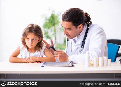 The young doctor pediatrician with small girl. Young doctor pediatrician with small girl