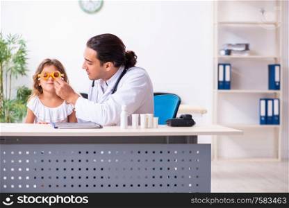 The young doctor pediatrician with small girl. Young doctor pediatrician with small girl
