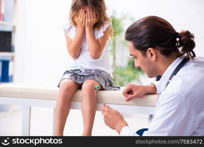 The young doctor pediatrician with small girl. Young doctor pediatrician with small girl