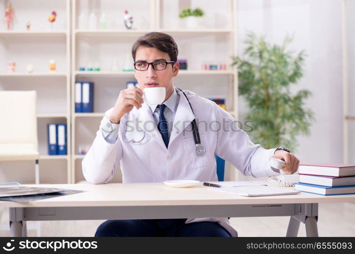 The young doctor sitting in the office. Young doctor sitting in the office