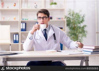 The young doctor sitting in the office. Young doctor sitting in the office