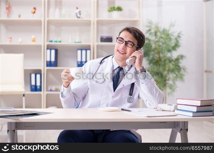The young doctor sitting in the office. Young doctor sitting in the office