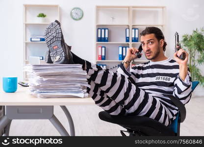 The young employee feeling like prisoner at work. Young employee feeling like prisoner at work