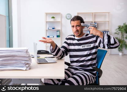 The young employee feeling like prisoner at work. Young employee feeling like prisoner at work