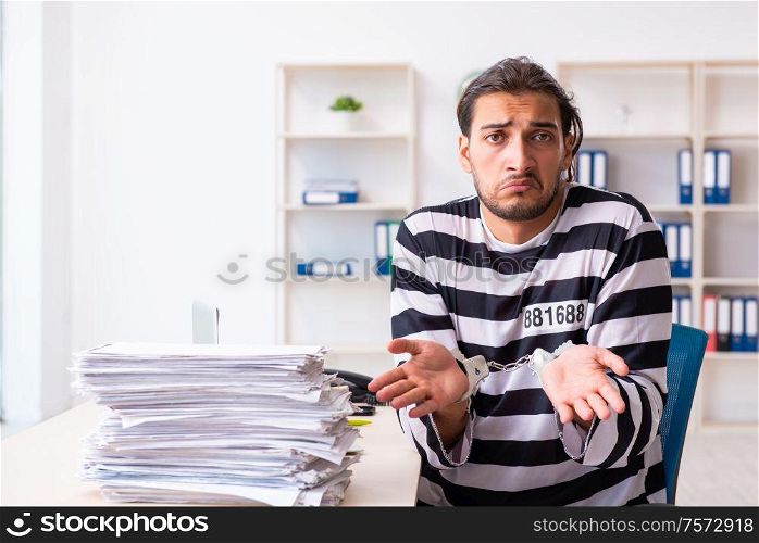 The young employee feeling like prisoner at work. Young employee feeling like prisoner at work