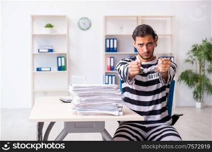 The young employee feeling like prisoner at work. Young employee feeling like prisoner at work