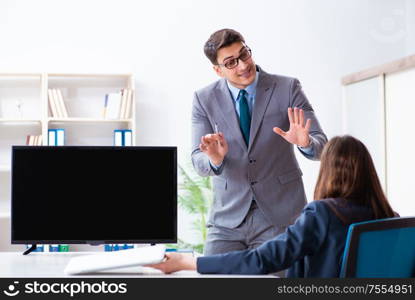 The young employee making presentation to his female boss. Young employee making presentation to his female boss