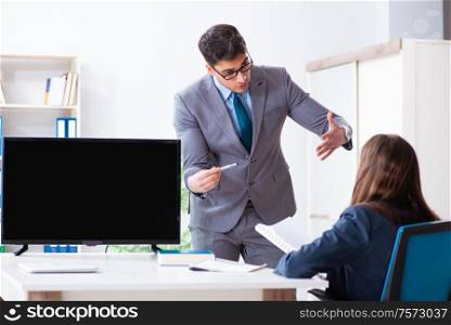 The young employee making presentation to his female boss. Young employee making presentation to his female boss