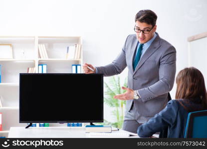 The young employee making presentation to his female boss. Young employee making presentation to his female boss