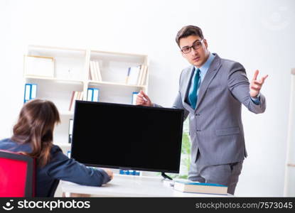 The young employee making presentation to his female boss. Young employee making presentation to his female boss