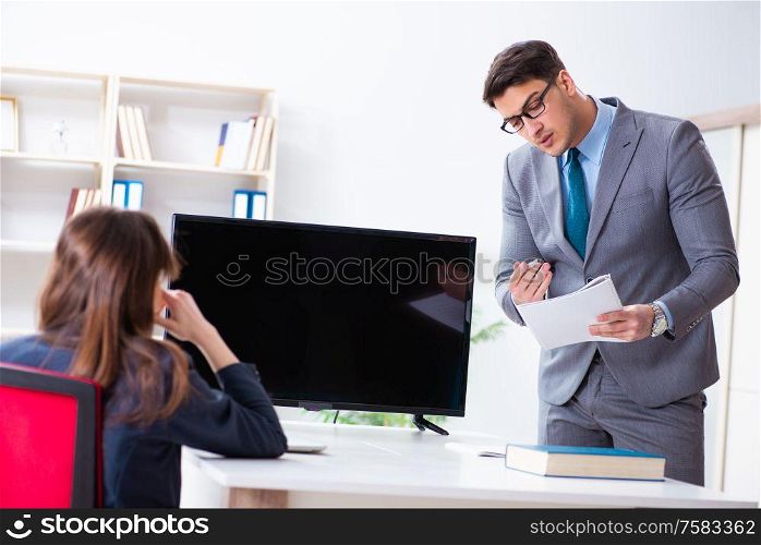 The young employee making presentation to his female boss. Young employee making presentation to his female boss